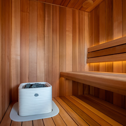 White sauna heater in a wooden sauna room