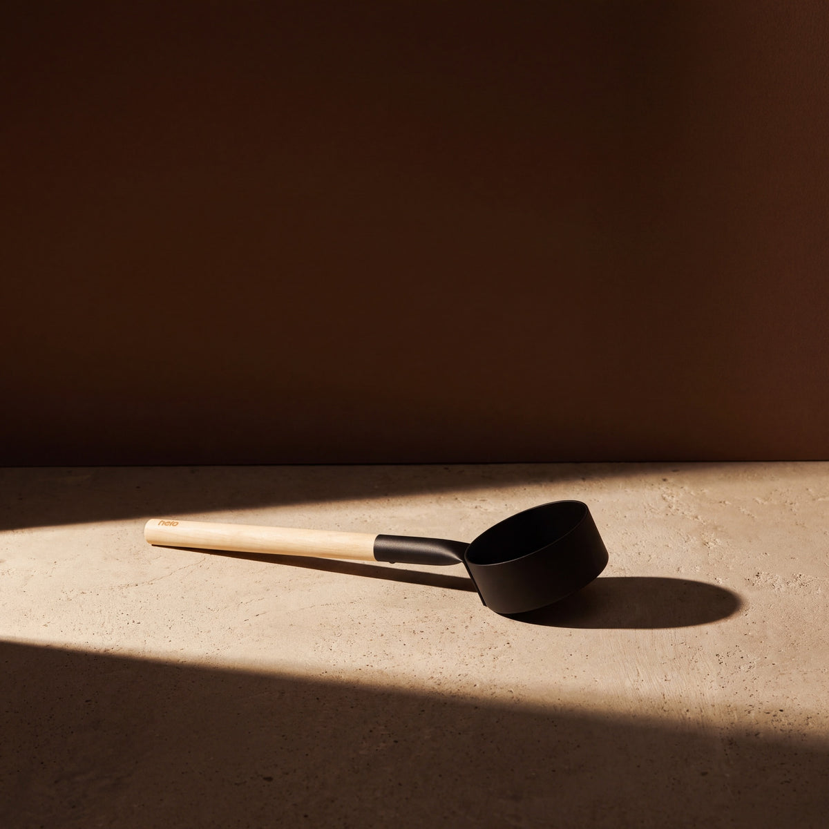 Black Anodised Aluminium Sauna Ladle (Brilliant Range) by Helo - lifestyle in sunlight