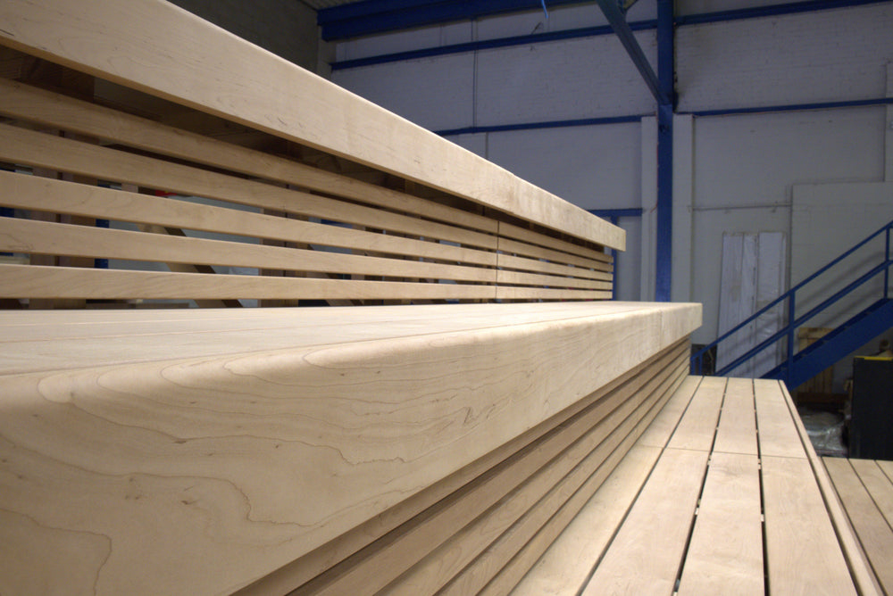 Wooden slat bench in a warehouse setting