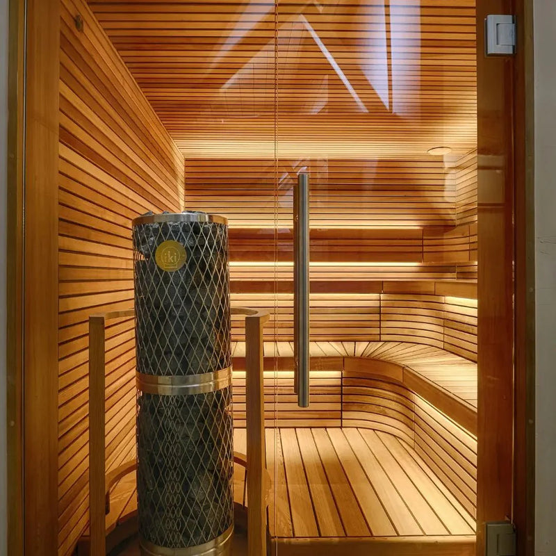 Sauna with warm lighting and a stone lined heater