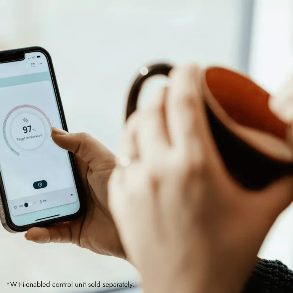 Person using a smartphone app to control a device, with a focus on the app interface.