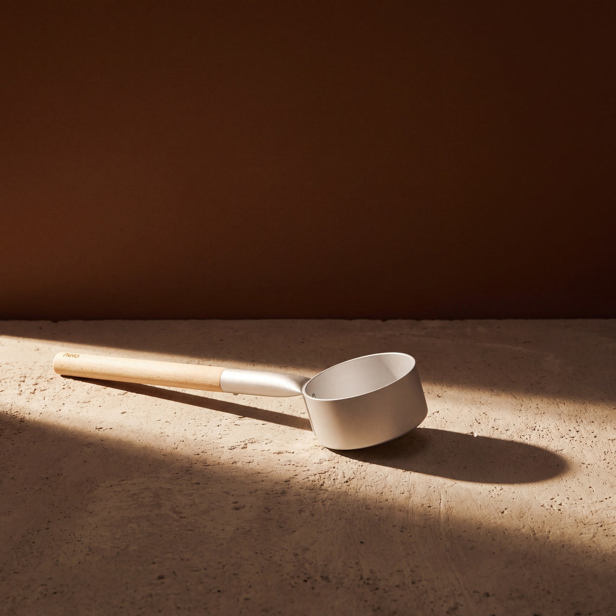 Silver Anodised Aluminium Sauna Ladle (Brilliant Range) by Helo - lifestyle in sunlight