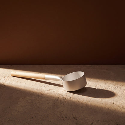 Silver Anodised Aluminium Sauna Ladle (Brilliant Range) by Helo - lifestyle in sunlight