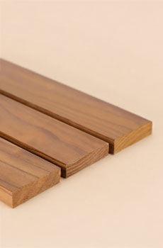 Three wooden slats on a beige background