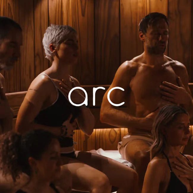 Group of people in a sauna with 'arc' branding.