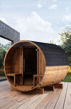 Wooden barrel-shaped sauna on a wooden deck with a clear sky background