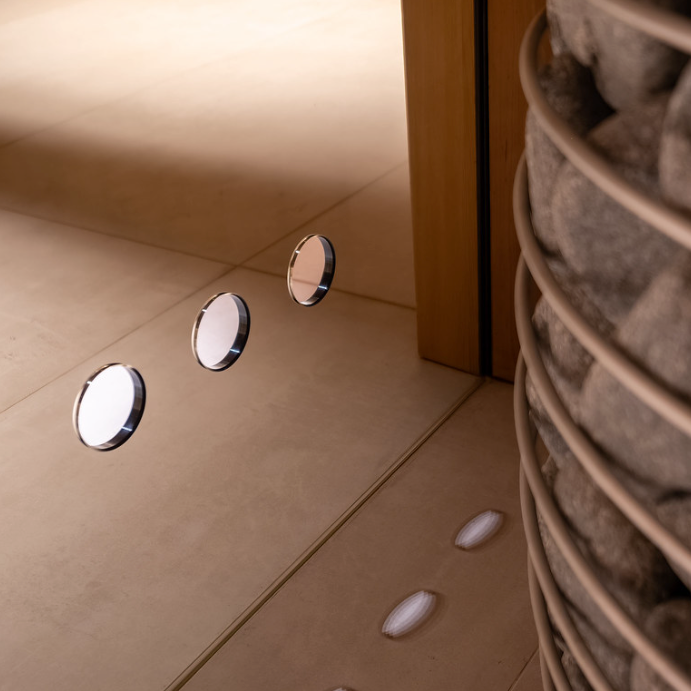 Close-up of a glass wall with circular holes.