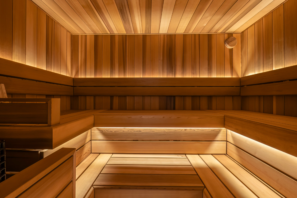 Wooden sauna interior with benches and warm lighting