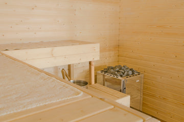 A simple L-shaper Spruce sauna installation with Spruce Sauna Cladding and Spruce Bench Boards. The heater is a Narvi Ultra Electric Sauna Heater.