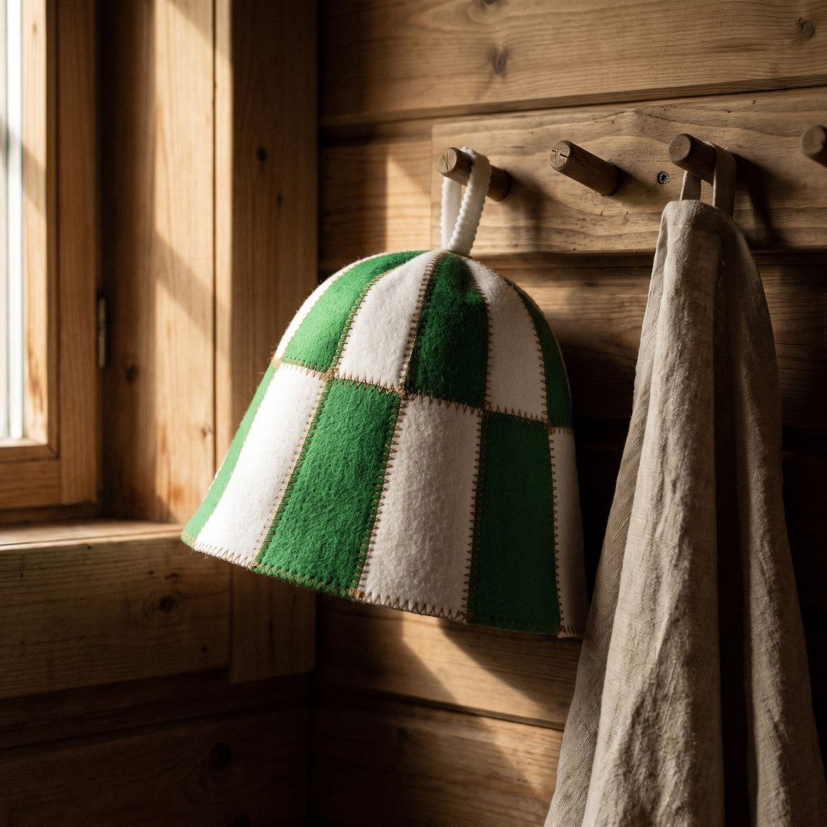 Sauna Hat Green/White (Polyester Felt) - hanging on a sauna peg
