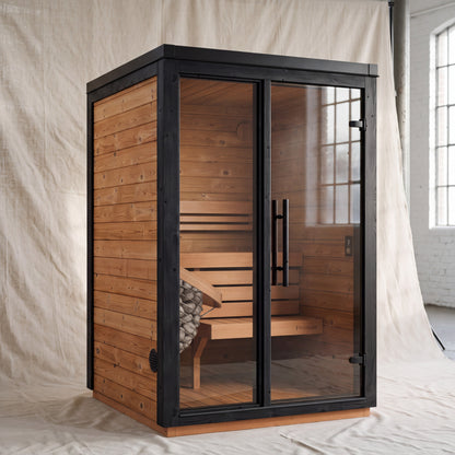 Fjelda Small outdoor sauna with a sloped roof and bronze tinted glazed front