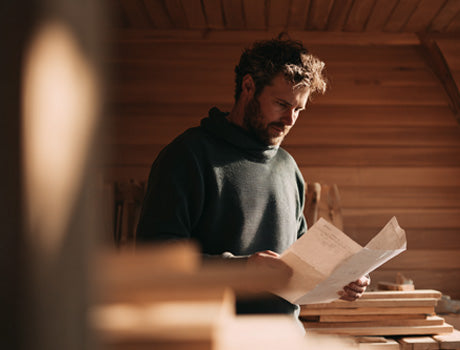 Man reading documents in a wooden room