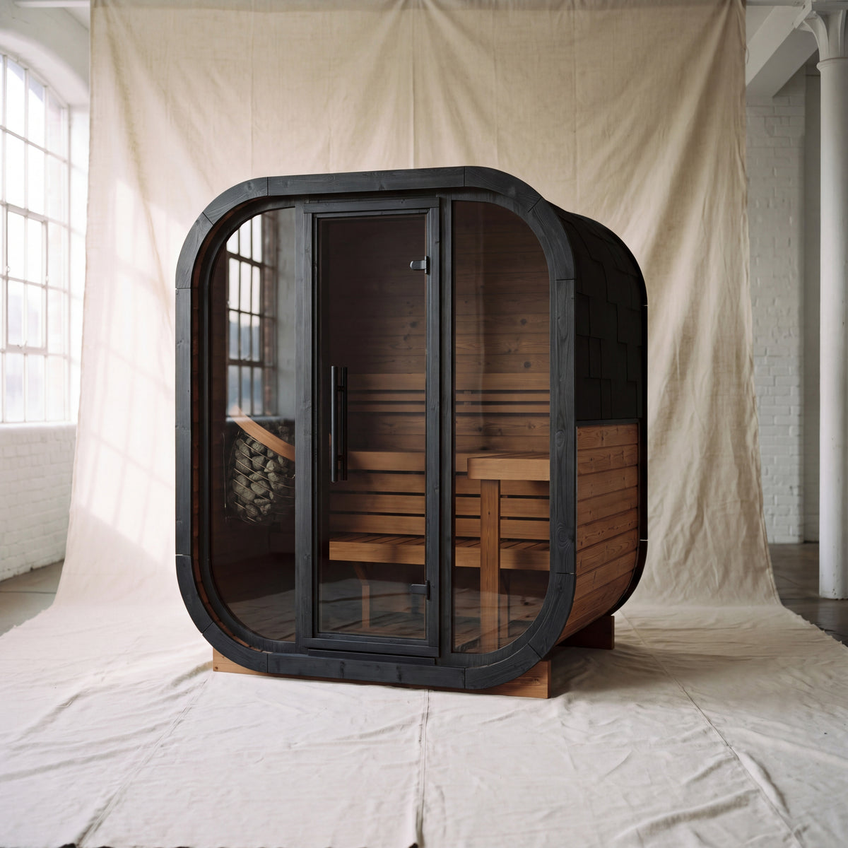 Ralva Medium rounded outdoor sauna with a full glass front and bitumen shingle roof