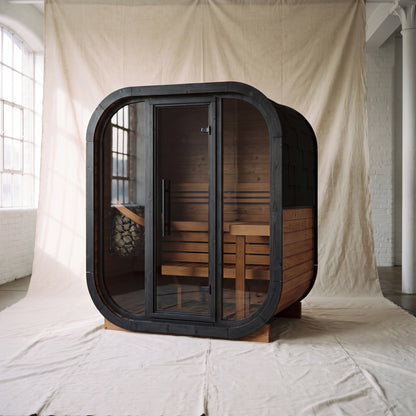Ralva Medium rounded outdoor sauna with a full glass front and bitumen shingle roof