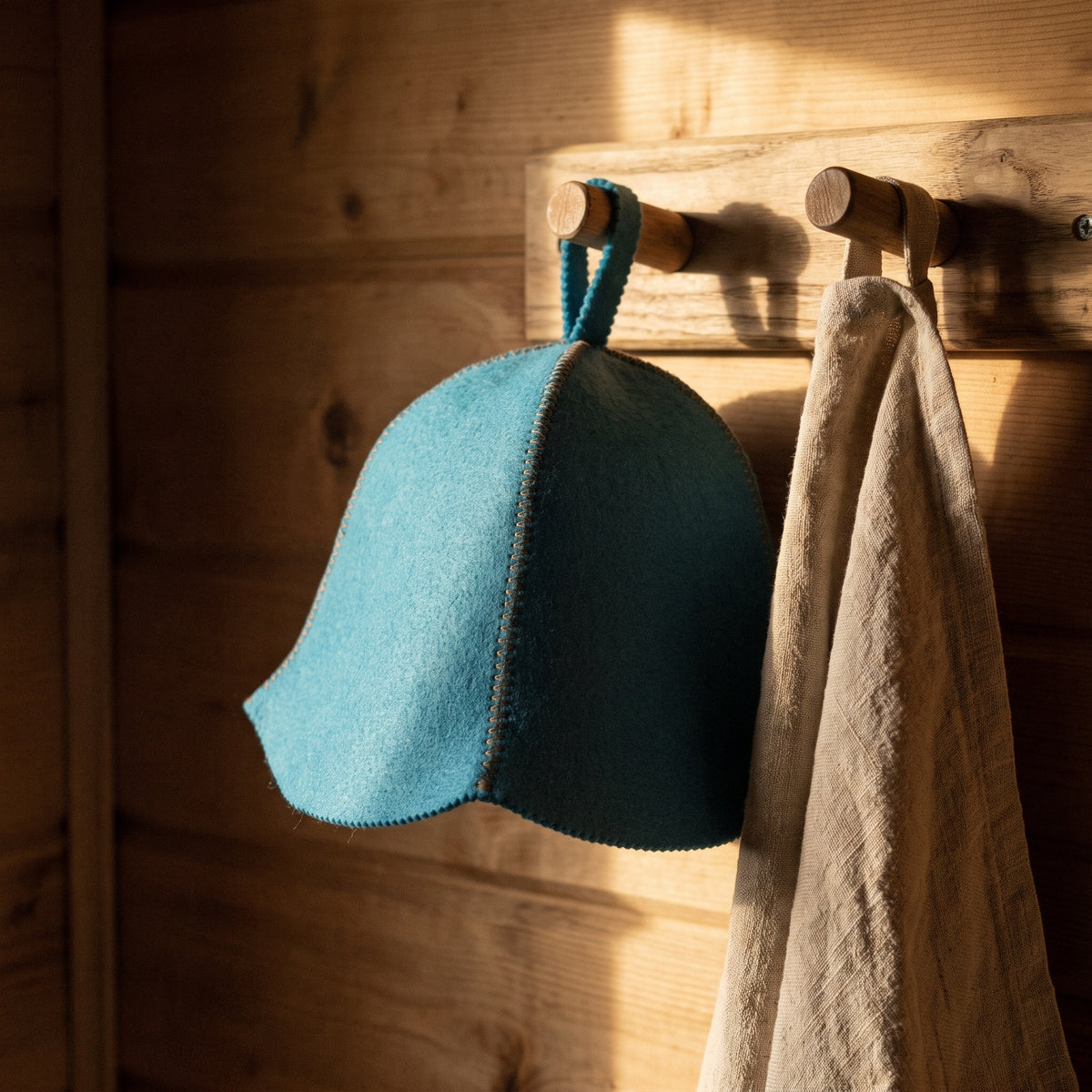 Traditional Lightweight Light Blue Felt Sauna Hat - hanging on a sauna peg
