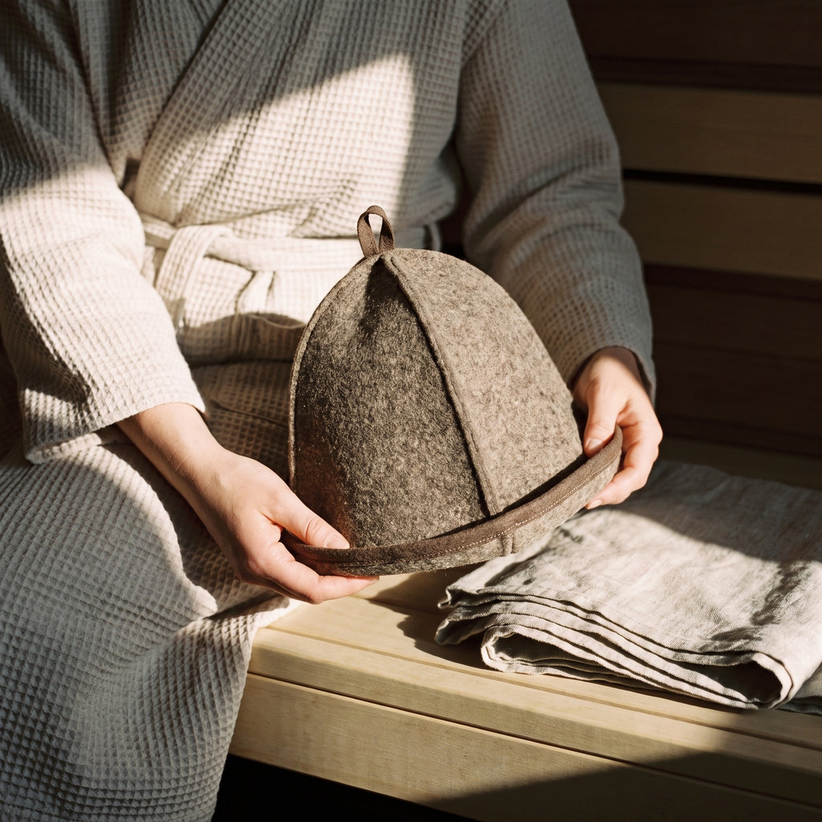 Emendo Felt Sauna Hat Brown - held in hands