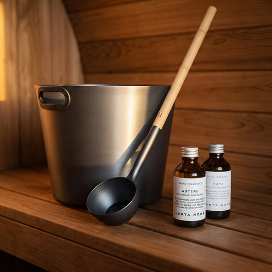 Rento dark grey sauna bucket and extra-long ladle with Luhta Autere and Tupa sauna oil drops on a sauna bench