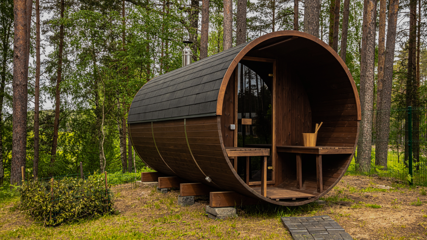 Wooden barrel-shaped cabin in a forest setting