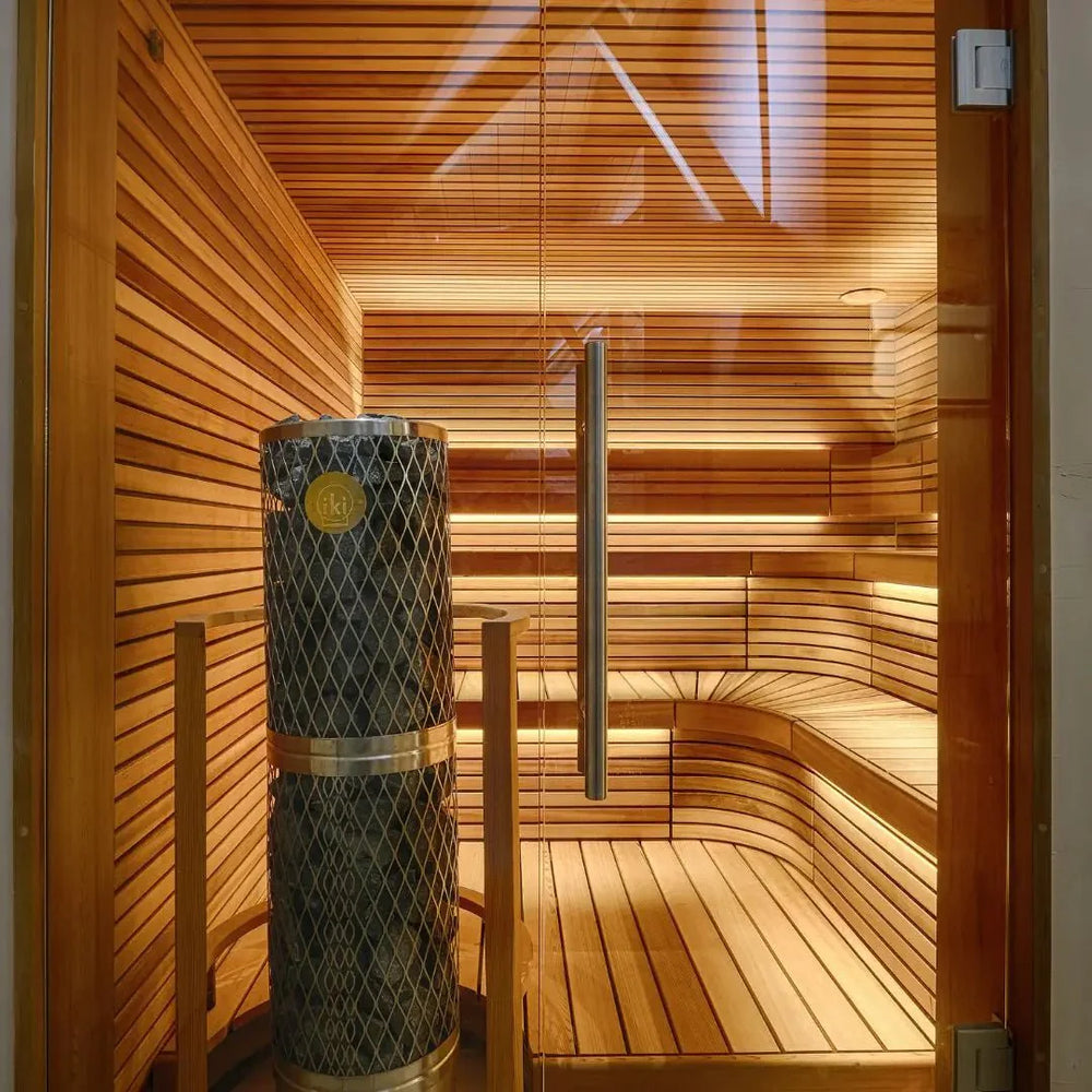 Sauna with warm lighting and a stone lined heater