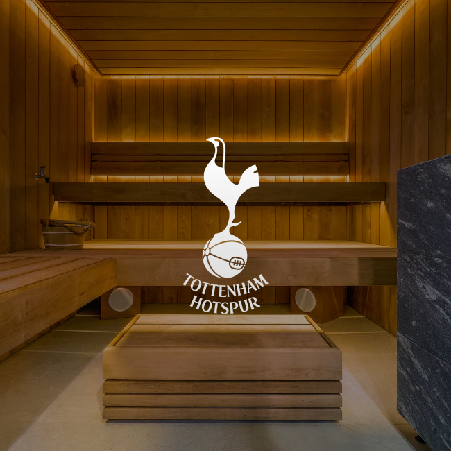 Tottenham Hotspur logo on a wooden bench in a sauna setting