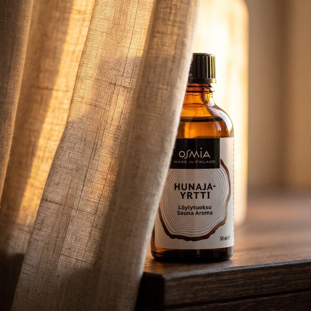 Honey Herb Sauna Aroma by Osmia (50ml) - lifestyle behind linen curtain
