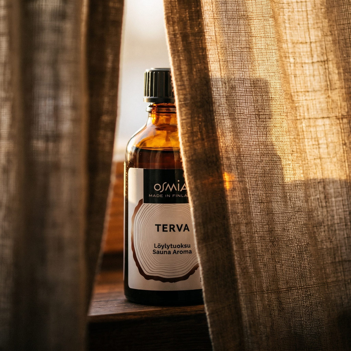Tar Sauna Aroma by Osmia (50ml) - lifestyle behind linen curtain