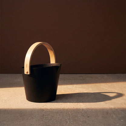 Black Anodised Aluminium Sauna Bucket (Brilliant Range) by Helo - lifestyle in sunlight