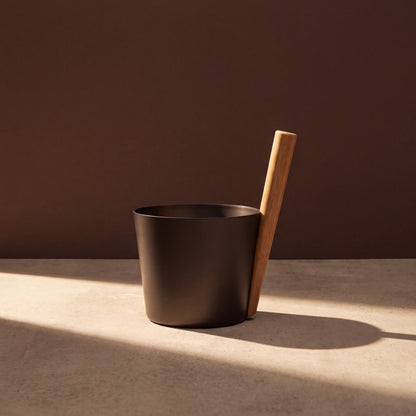 Rento 5l Anodised Aluminium Sauna Pail in Brown/Black - lifestyle in sunlight